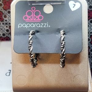 Glistening silver bars wrap into an edgy twisted hoop for a casual look.